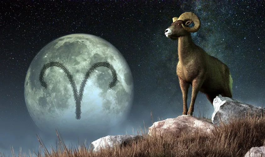 Aries Zodiac symbol on a moon with a ram standing on a rock