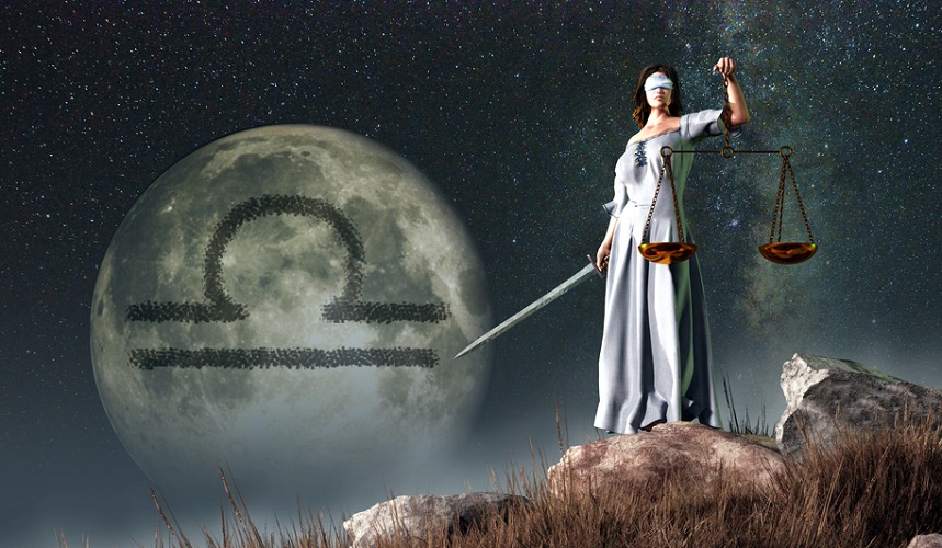 Libra zodiac sign symbol on a moon in the background and a woman holding scales and a sword in the near ground