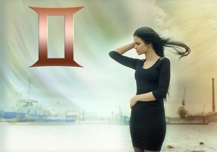 Fashionable woman in a black dress with wind swept hair and a Gemini zodiac sign symbol on the left