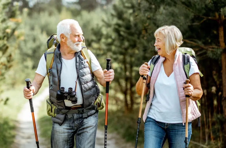 Older couple hiking down an off-road countryside path