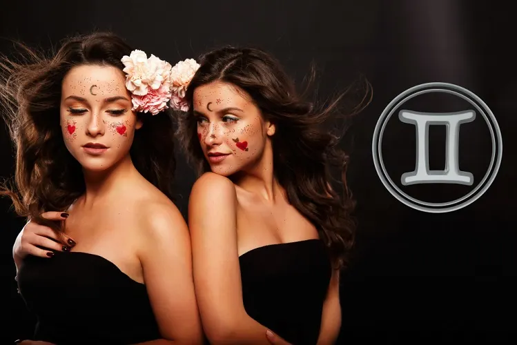 Two twin sisters with pink roses in their hair with a black background and a Gemini symbol on the right